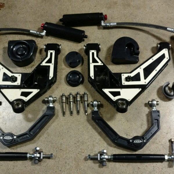 Various CNC machined automotive parts laid out on a surface